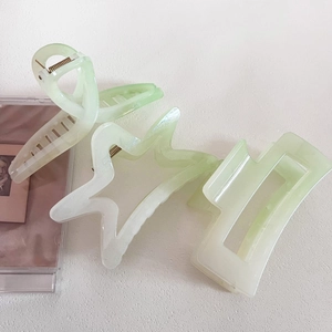 Detailed set of mint green pearlescent hair clips in star and geometric shapes