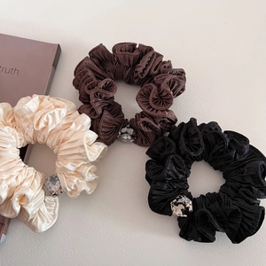 Three-piece pleated fabric hair scrunchies in cream, brown, and black with rhinestones