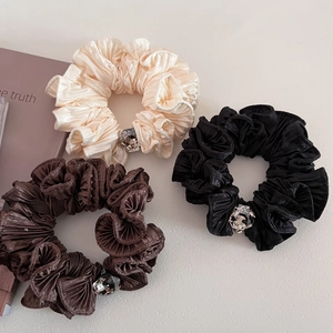Three elegant pleated satin hair scrunchies with large clear crystals in black and cream