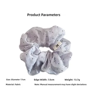 Blue polka dot scrunchie detail showing 17cm diameter and logo label on fabric