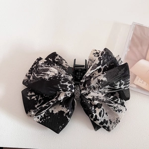 Detail of vintage ink print chiffon bow hair claw clip with crystal center embellishment
