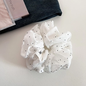 French style white polka dot scrunchie with cute bow label on soft textured fabric