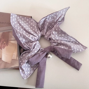Detailed view of lavender polka dot bow scrunchie with long ribbons and pearl charm