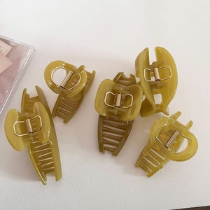 Set of five olive green jelly textured hair claws with durable golden springs for styling
