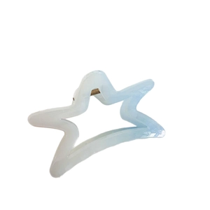 Star shaped hair claw clip featuring light blue and white gradient with gold spring