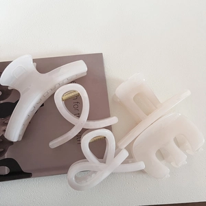 Set of minimalist cream jelly hair claws in various elegant geometric shapes