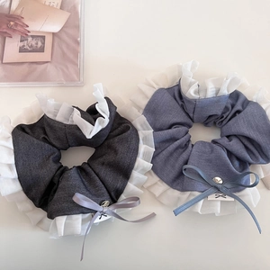 Detailed macro view of denim scrunchies with white pleated chiffon lace and delicate bows