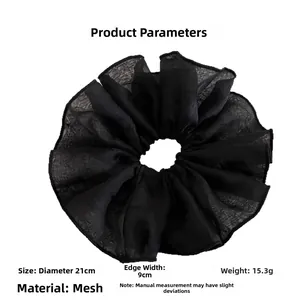 Detail of a large 21cm oversized black sheer mesh scrunchie with layered pleats