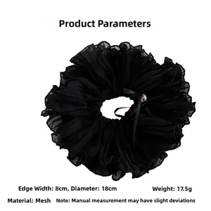 Detail of 18cm black ruffled organza scrunchie with bow and clear bead accent