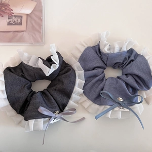 Close-up of pleated grey and light blue mesh scrunchies with elegant ribbon bows