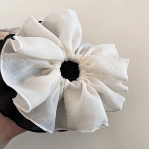 Detail of extra large pleated tulle scrunchie in black and white mesh fabric