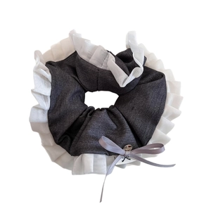 Dark grey scrunchie with white ruffled edges and silk bow featuring a silver bead