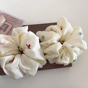 Elegant beige scrunchies set with colorful flower embroidery for stylish hair styling