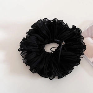 Detail of black pleated chiffon scrunchie with crystal bead and ribbon decoration