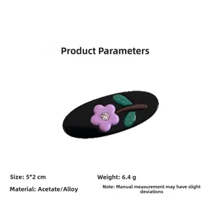 Detail view of oval acetate hair clip with purple flower and rhinestone on white background
