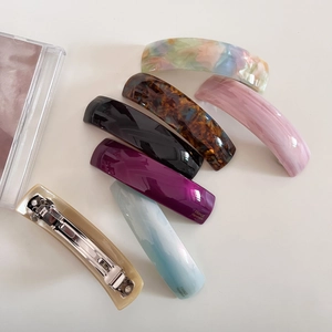Detail showing variety of acetate hair clips with metal spring clips and France Handmade text