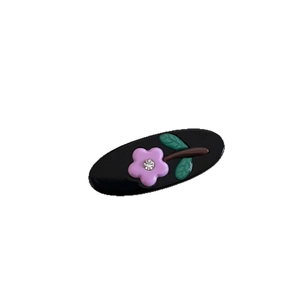 Polished black oval acetate hair clip featuring a delicate purple flower with rhinestone