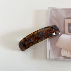 Classic tortoise shell acetate hair clip with gold France Handmade logo on white background