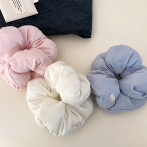 Three-piece set of cream puff cotton scrunchies in pink, beige, and blue with bow buckles