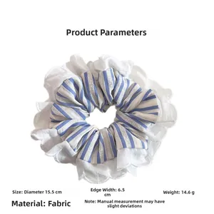 Detail view of a blue white striped scrunchie with delicate white lace edges