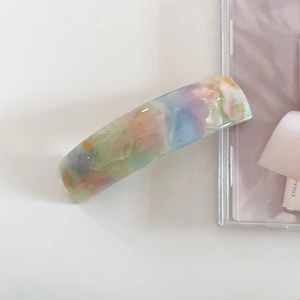 Close-up of acetic acid hair clip with marble texture and France handmade engraving