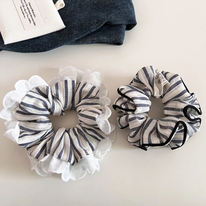 Set of blue and white striped scrunchies with lace trim and elegant fabric texture