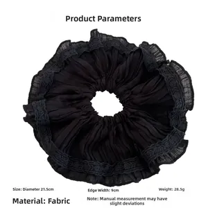 Detail of black pleated fabric hair scrunchie with lace trim edge and 21.5cm diameter