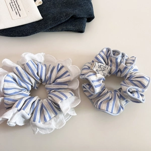 Detail of blue and white striped scrunchies with lace trim and vintage cloth label