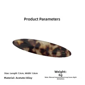 Detail view of tortoiseshell acetate hair clip with dimensions 7.3cm by 1.8cm
