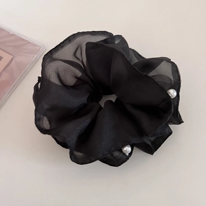 Detailed view of the layered black mesh scrunchie with delicate white pearls