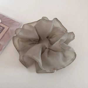 Detail view of large sage green organza scrunchie with white pearl trim and mesh texture