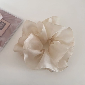 Close-up of double-layer organza scrunchie with delicate white pearls and fluffy mesh design