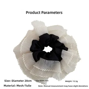 Close-up of oversize mesh scrunchie with 20cm diameter and lightweight tulle fabric detail