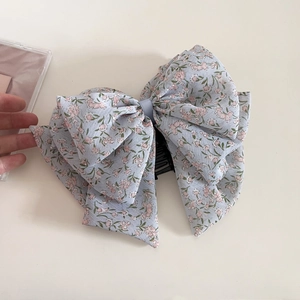 Detail of blue floral chiffon hair claw clip with bow design and vintage pattern