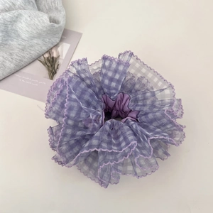 Detail of purple plaid mesh scrunchie with layered lace edges and elastic band