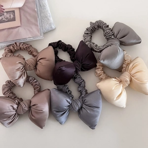 Set of minimalist satin bow hair scrunchies in elegant neutral colors for ponytails