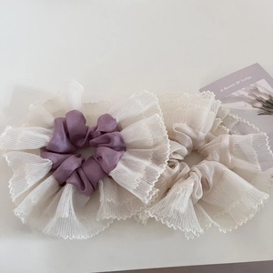 Detail of purple and champagne oversized mesh lace scrunchies in French romantic style