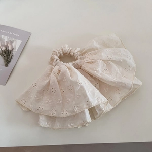 Detail of cream eyelet embroidery lace hair scrunchie with layered ruffle design