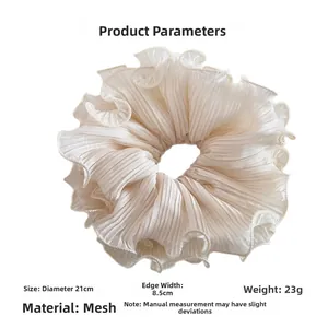 Macro detail of oversized ivory organza scrunchie showing 21cm diameter and gauzy texture