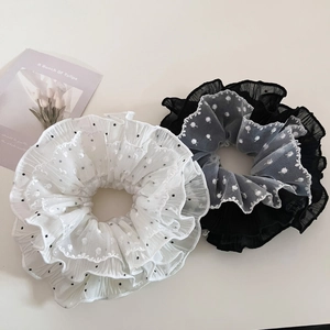 Elegant polka dot lace scrunchies in black and white mesh fabric for bun hairstyles