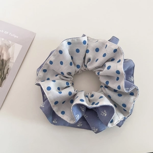 Detail of blue floral and polka dot double-layer scrunchie in soft cotton linen fabric