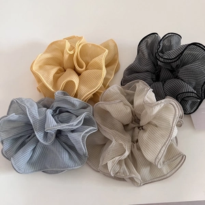 Set of four gingham chiffon hair scrunchies in yellow, black, blue, and beige colors