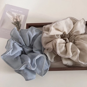 Detail of sweet checkered chiffon hair scrunchies on a wooden tray with a tulip card