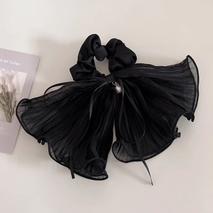 Elegant black layered mesh bow scrunchie with pleated texture and pearl pendant detail