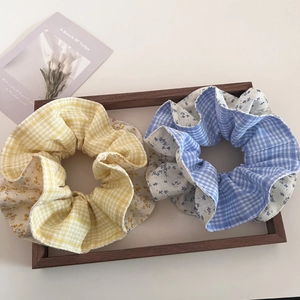 Detail of blue and yellow floral checkered scrunchies on a wooden tray with a tulip card