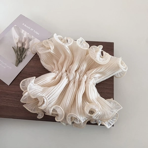 Elegant ivory ruffled scrunchie hair tie with fine pleated texture and lace edge