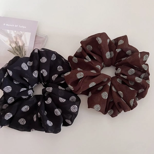 Vintage brown and black polka dot scrunchies with wavy texture for elegant ponytails