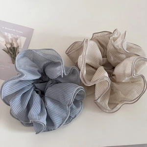 Detail of blue and beige gingham chiffon scrunchies with layered ruffled edges