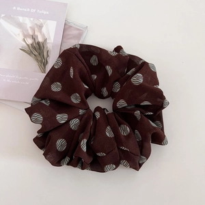 Detail of vintage brown chiffon scrunchie with blue polka dots and floral card decor