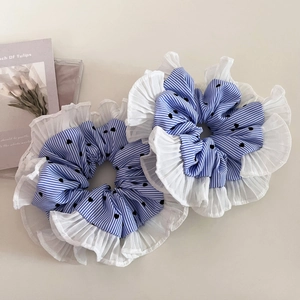 Detail of blue striped polka dot scrunchies with elegant white pleated organza edges